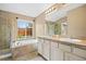 Main bathroom featuring a soaking tub, double sinks, a window, and a tiled shower at 4732 S Coolidge St, Aurora, CO 80016