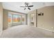 Large main bedroom with bay window, ceiling fan, neutral colors, and ensuite bathroom entrance at 4732 S Coolidge St, Aurora, CO 80016