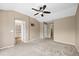Another view of the main bedroom, featuring a ceiling fan, neutral colors, and multiple doorways at 4732 S Coolidge St, Aurora, CO 80016