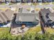 Aerial view of home showcasing landscaped backyard with patio, fire pit, and lush lawn at 15137 W 50Th Pl, Golden, CO 80403