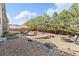 Large backyard featuring a fire pit area, a patio with lounge chairs, and a dining table under an umbrella at 15137 W 50Th Pl, Golden, CO 80403