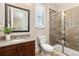 A powder room features a glass shower, tile and wood cabinets at 15137 W 50Th Pl, Golden, CO 80403