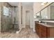 This primary bathroom has a glass enclosed shower and wood cabinets at 15137 W 50Th Pl, Golden, CO 80403