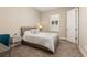 This bedroom has neutral decor, carpet and a comfortable bed at 15137 W 50Th Pl, Golden, CO 80403