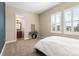This carpeted bedroom has large windows and a bathroom view at 15137 W 50Th Pl, Golden, CO 80403