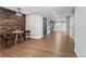 Stylish dining area featuring hardwood floors, a wooden accent wall, and a modern table with two chairs at 15137 W 50Th Pl, Golden, CO 80403