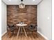Close-up view of a stylish dining area featuring a wooden accent wall and modern table setting with chairs at 15137 W 50Th Pl, Golden, CO 80403