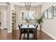 Elegant dining room featuring a modern chandelier, plantation shutters, and stylish decor at 15137 W 50Th Pl, Golden, CO 80403