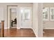 Bright entryway showcasing hardwood floors, a frosted glass door, and views into an office space at 15137 W 50Th Pl, Golden, CO 80403