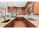 Chef's kitchen featuring professional-grade appliances, granite countertops, and custom cabinetry for ample storage at 15137 W 50Th Pl, Golden, CO 80403