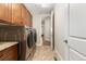The laundry room has a modern washer and dryer with cabinets at 15137 W 50Th Pl, Golden, CO 80403
