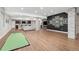 Open concept living room with mini golf, bar, fireplace, TV and modern decor, perfect for entertaining at 15137 W 50Th Pl, Golden, CO 80403
