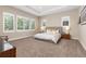 Serene main bedroom with large windows, plush carpeting, and a tray ceiling, providing a relaxing retreat at 15137 W 50Th Pl, Golden, CO 80403