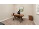 A naturally lit home office features a modern desk and neutral decor at 15137 W 50Th Pl, Golden, CO 80403