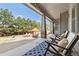 Relaxing covered patio with outdoor seating, a blue rug, and views of the landscaped backyard and blue sky at 15137 W 50Th Pl, Golden, CO 80403