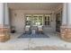 Cozy covered patio features stylish rocking chairs, string lights, and access to the home's interior at 15137 W 50Th Pl, Golden, CO 80403