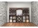 Custom wine cellar with wooden racks, brick accents, and hardwood floors perfect for storing your wine collection at 15137 W 50Th Pl, Golden, CO 80403