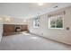 Spacious basement living area features a brick fireplace, carpeted floors, and ample natural light at 19322 E Eldorado Dr, Aurora, CO 80013