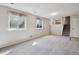 Finished basement with neutral carpet, plenty of natural light, and stairs to the upper level at 19322 E Eldorado Dr, Aurora, CO 80013
