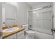 Bathroom featuring a vanity sink, toilet, and shower/tub with sliding glass door at 19322 E Eldorado Dr, Aurora, CO 80013