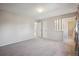 Spacious primary bedroom with neutral carpet, light walls, and entrance to the en suite bathroom at 19322 E Eldorado Dr, Aurora, CO 80013