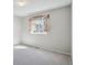 Bedroom with a light grey carpet and paint and natural light from the window at 19322 E Eldorado Dr, Aurora, CO 80013