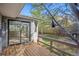 Cozy wooden deck adjacent to a sunroom, perfect for outdoor relaxation at 19322 E Eldorado Dr, Aurora, CO 80013