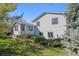 Rear exterior view showing vinyl siding, sunroom addition, and well-manicured lawn at 19322 E Eldorado Dr, Aurora, CO 80013