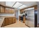 Modern kitchen with wood cabinets, granite countertops, stainless steel appliances, and laminate flooring at 19322 E Eldorado Dr, Aurora, CO 80013