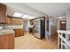 Updated kitchen boasts wood cabinets, granite countertops, stainless steel appliances, and wood laminate floors at 19322 E Eldorado Dr, Aurora, CO 80013