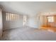 Spacious living room with neutral carpet and view into the dining room at 19322 E Eldorado Dr, Aurora, CO 80013