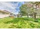 Spacious backyard with lush green grass, mature trees, hot tub, and pergola with seating area at 2464 Remington Rd, Elizabeth, CO 80107