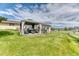 Large backyard featuring a pergola with seating area, mature trees, and views of the property at 2464 Remington Rd, Elizabeth, CO 80107