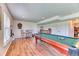 Finished basement with a pool table, bar, and wood laminate flooring, perfect for entertaining guests at 2464 Remington Rd, Elizabeth, CO 80107