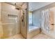 Modern bathroom with new tile shower, glass door, and separate soaking tub at 2464 Remington Rd, Elizabeth, CO 80107