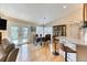 Open dining room with hardwood floors, view to living room, and natural light at 2464 Remington Rd, Elizabeth, CO 80107