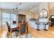 Dining room and kitchen featuring hardwood floors, granite countertops, and stainless steel appliances at 2464 Remington Rd, Elizabeth, CO 80107