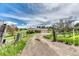 Inviting home with a gravel driveway, fenced yard, and mature trees, offering a serene country setting at 2464 Remington Rd, Elizabeth, CO 80107