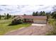 Charming ranch-style home with a spacious front yard and a welcoming front porch at 2464 Remington Rd, Elizabeth, CO 80107