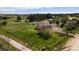 Beautiful ranch home on sprawling green land with mature trees, fencing and lovely blue skies at 2464 Remington Rd, Elizabeth, CO 80107