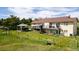 The back of a two-story home with a large deck, gazebo and green lawn surrounded by mature trees at 2464 Remington Rd, Elizabeth, CO 80107