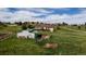 Exterior aerial shot of a spacious two-story home with barn and horse property, surrounded by trees and green pastures at 2464 Remington Rd, Elizabeth, CO 80107