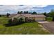 Charming ranch home with a two-car garage and front porch, surrounded by a lush green lawn and mature trees at 2464 Remington Rd, Elizabeth, CO 80107
