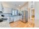 Modern kitchen with stainless steel appliances, granite countertops, and hardwood floors at 2464 Remington Rd, Elizabeth, CO 80107