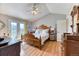 Bright and airy main bedroom with hardwood flooring, balcony, and ample closet space at 2464 Remington Rd, Elizabeth, CO 80107