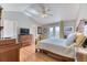 Bright main bedroom featuring vaulted ceilings, hardwood floors, ceiling fan, and a private balcony with pastoral views at 2464 Remington Rd, Elizabeth, CO 80107