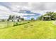 Lush green lawn featuring a white barn, fenced area, and a pergola with seating area at 2464 Remington Rd, Elizabeth, CO 80107