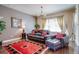 Relaxing living room featuring leather seating, a red rug, and large windows at 9129 Kornbrust Dr, Lone Tree, CO 80124