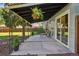 Charming back patio with a covered area, cozy seating, and lush hanging plants perfect for relaxation at 1431 S Glencoe St, Denver, CO 80222