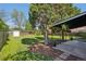Expansive backyard featuring a well-maintained lawn, mature trees, a storage shed, and a covered patio area at 1431 S Glencoe St, Denver, CO 80222